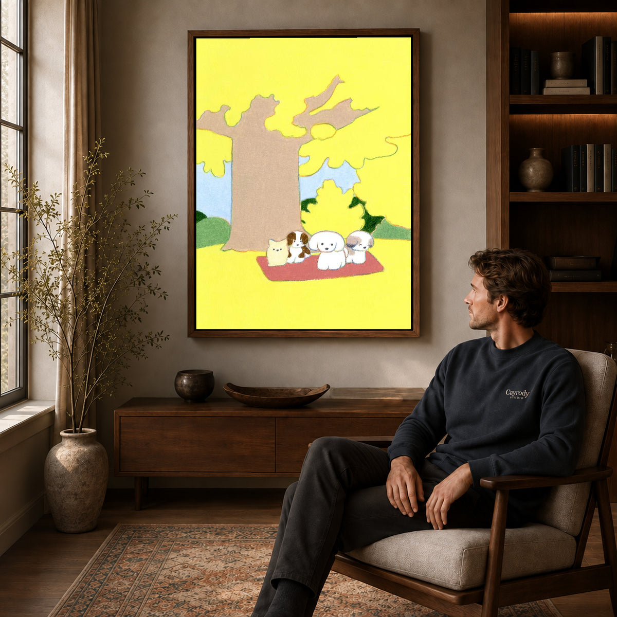 gentle autumn pet picnic canvas art in a walnut frame above a console beside a seated man.