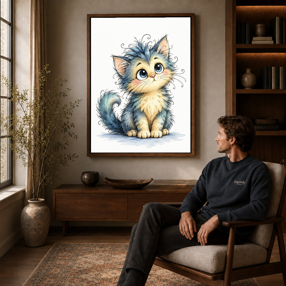 whimsical fluffy kitten canvas art in a walnut frame above a console beside a seated man.