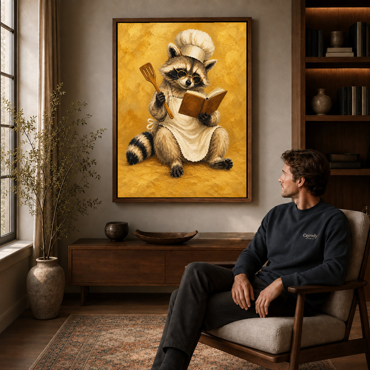 vintage raccoon chef canvas art in a walnut frame above a console beside a seated man.