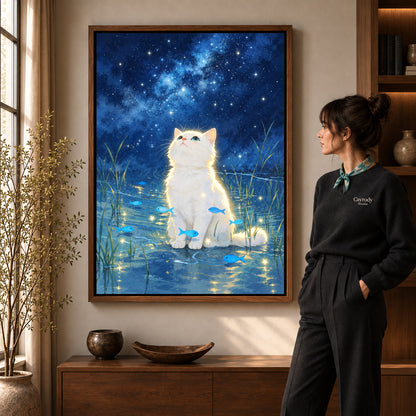 dreamy starlight kitten canvas art in a walnut frame beside a standing woman and wooden console.