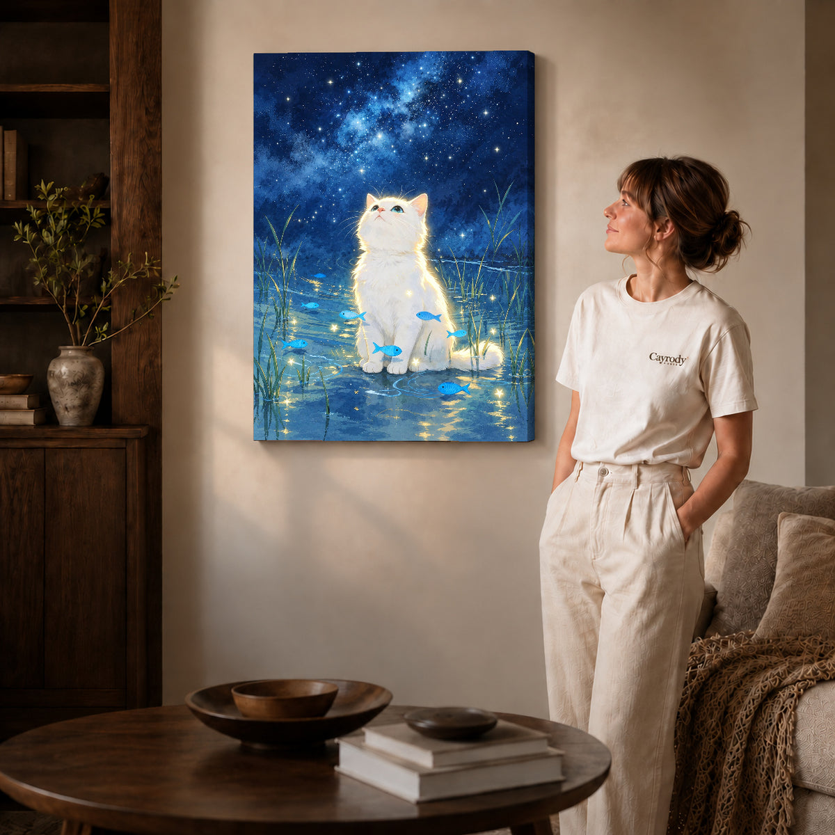dreamy starlight kitten canvas art on gallery-wrapped canvas with natural edge shading beside a standing woman.