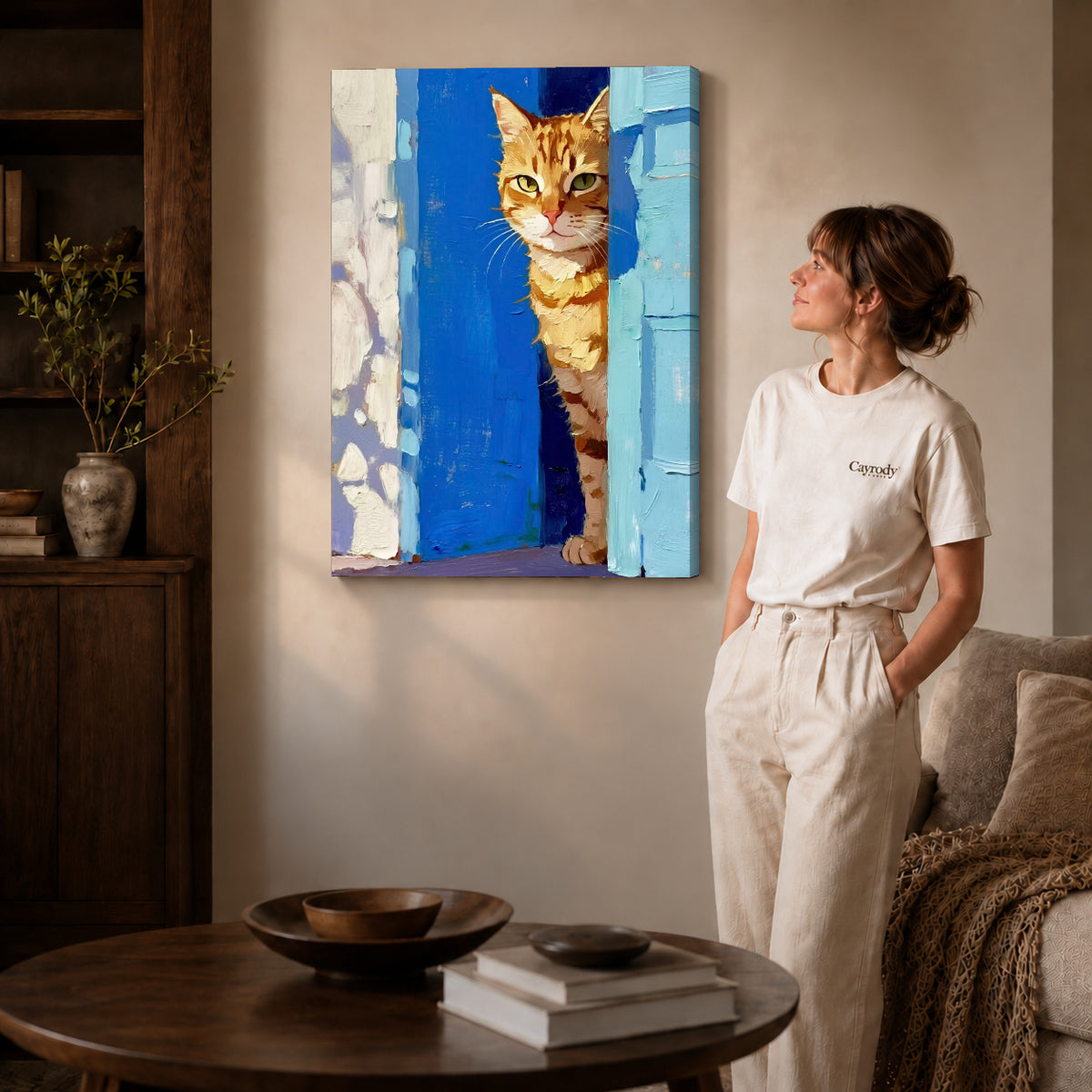 painterly doorway cat canvas art on gallery-wrapped canvas with natural edge shading beside a standing woman.