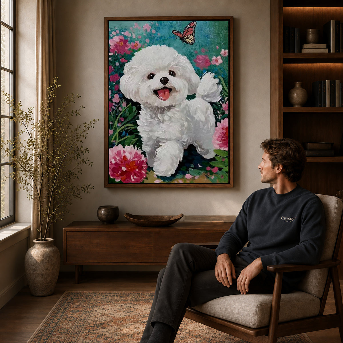 joyful puppy garden canvas art in a walnut frame above a console beside a seated man.