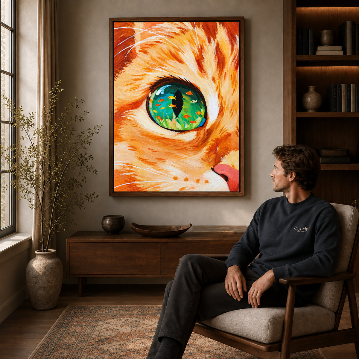surreal aquarium cat canvas art in a walnut frame above a console beside a seated man.