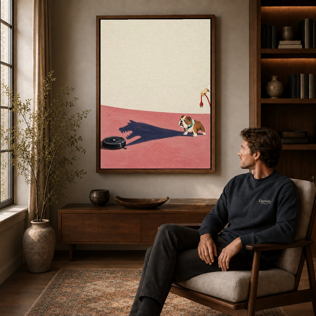 brave bulldog shadow canvas art in a walnut frame above a console beside a seated man.