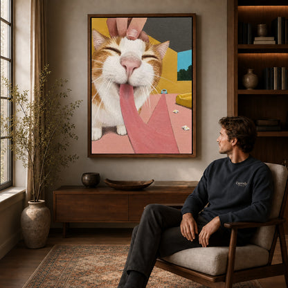 blissful long tongue cat canvas art in a walnut frame above a console beside a seated man.