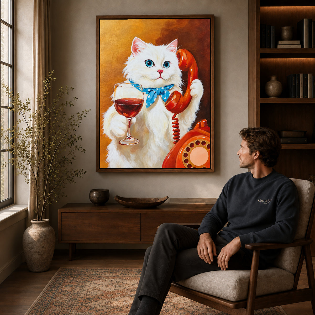 vintage telephone wine cat canvas art in a walnut frame above a console beside a seated man.
