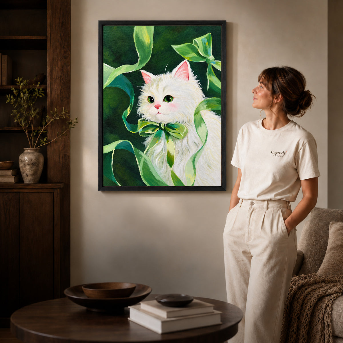 green ribbon kitten canvas art shown in the black frame option against a softly lit wall.