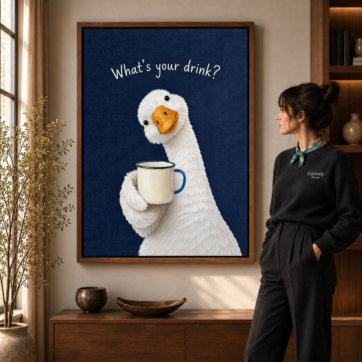 playful coffee duck canvas art in a walnut frame beside a standing woman and wooden console.