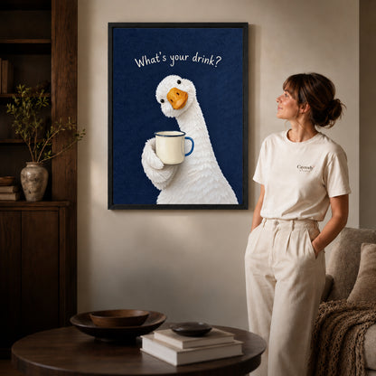 playful coffee duck canvas art in a black frame beside a woman and round wooden table.