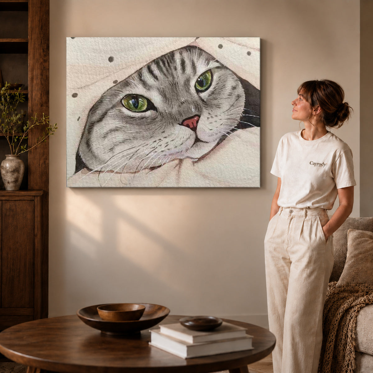 cozy blanket tabby canvas art on gallery-wrapped canvas with visible edge depth beside a standing woman.