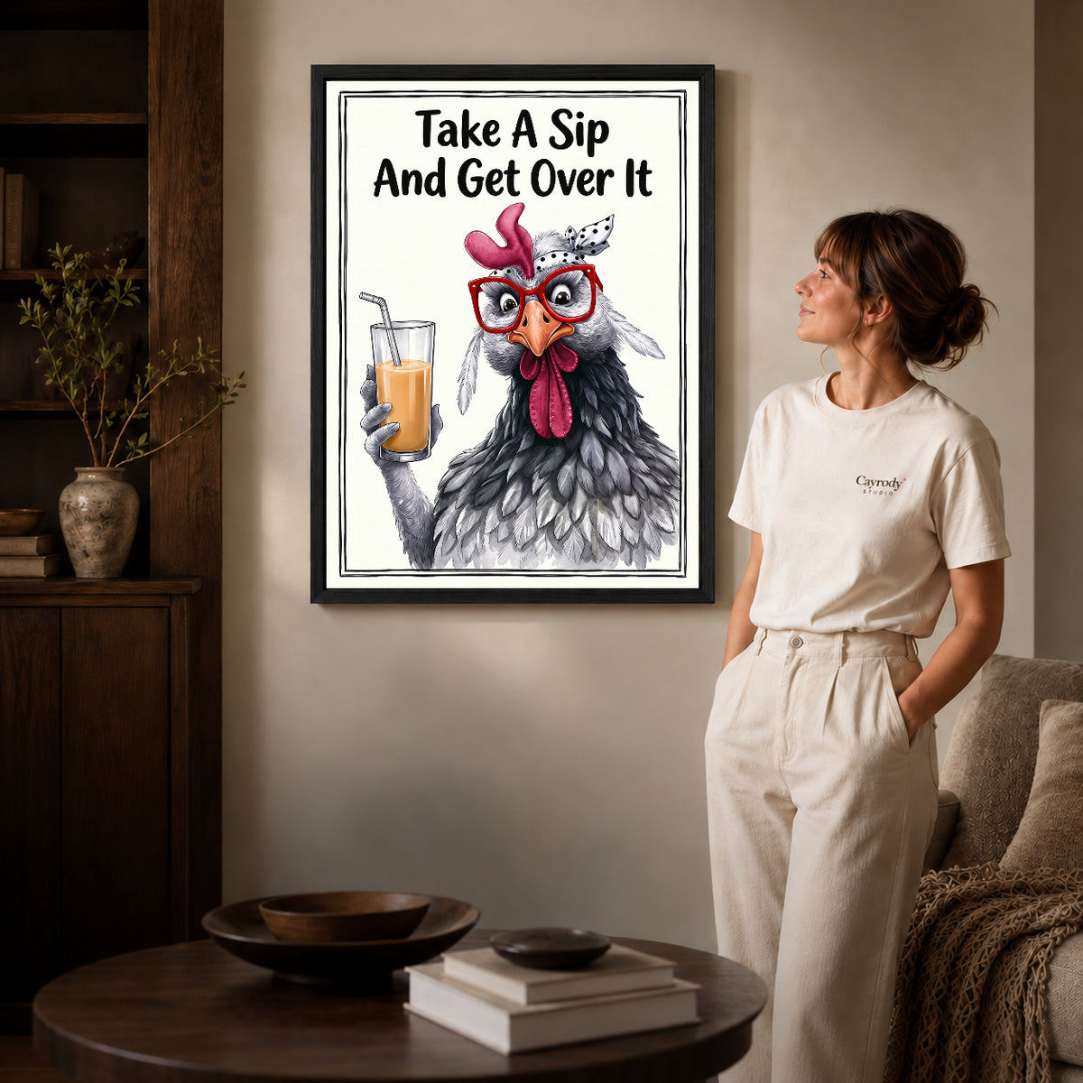 cheeky drink chicken canvas art shown in the black frame option against a softly lit wall.
