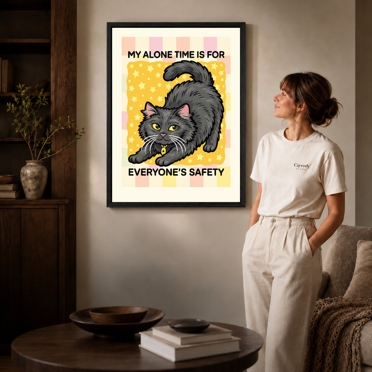 playful alone time cat canvas art shown in the black frame option against a softly lit wall.