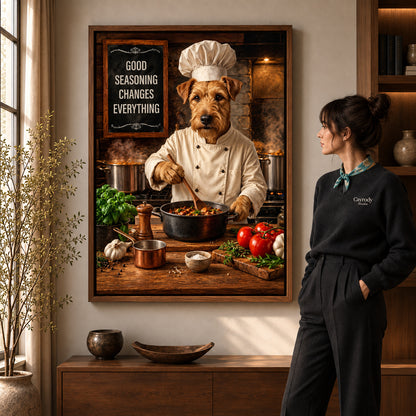 warm terrier chef canvas art in a walnut frame beside a standing woman and wooden console.