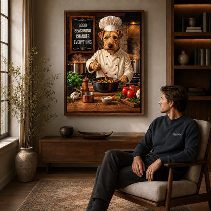 warm terrier chef canvas art in a walnut frame above a console beside a seated man.