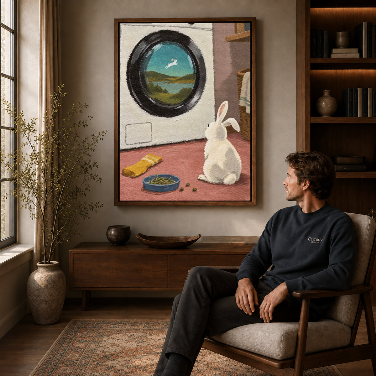 dreamy laundry rabbit canvas art in a walnut frame above a console beside a seated man.