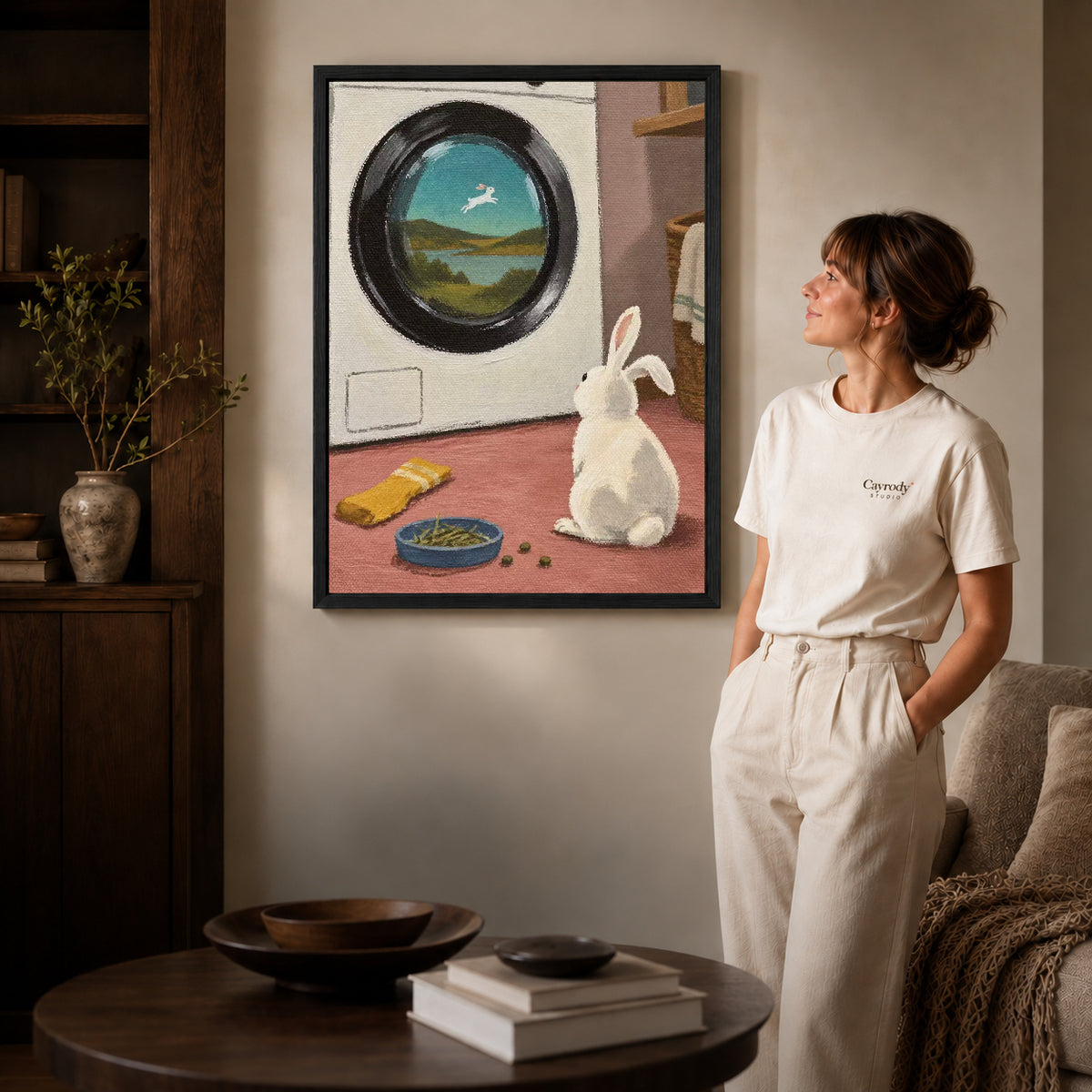 dreamy laundry rabbit canvas art shown in the black frame option against a softly lit wall.