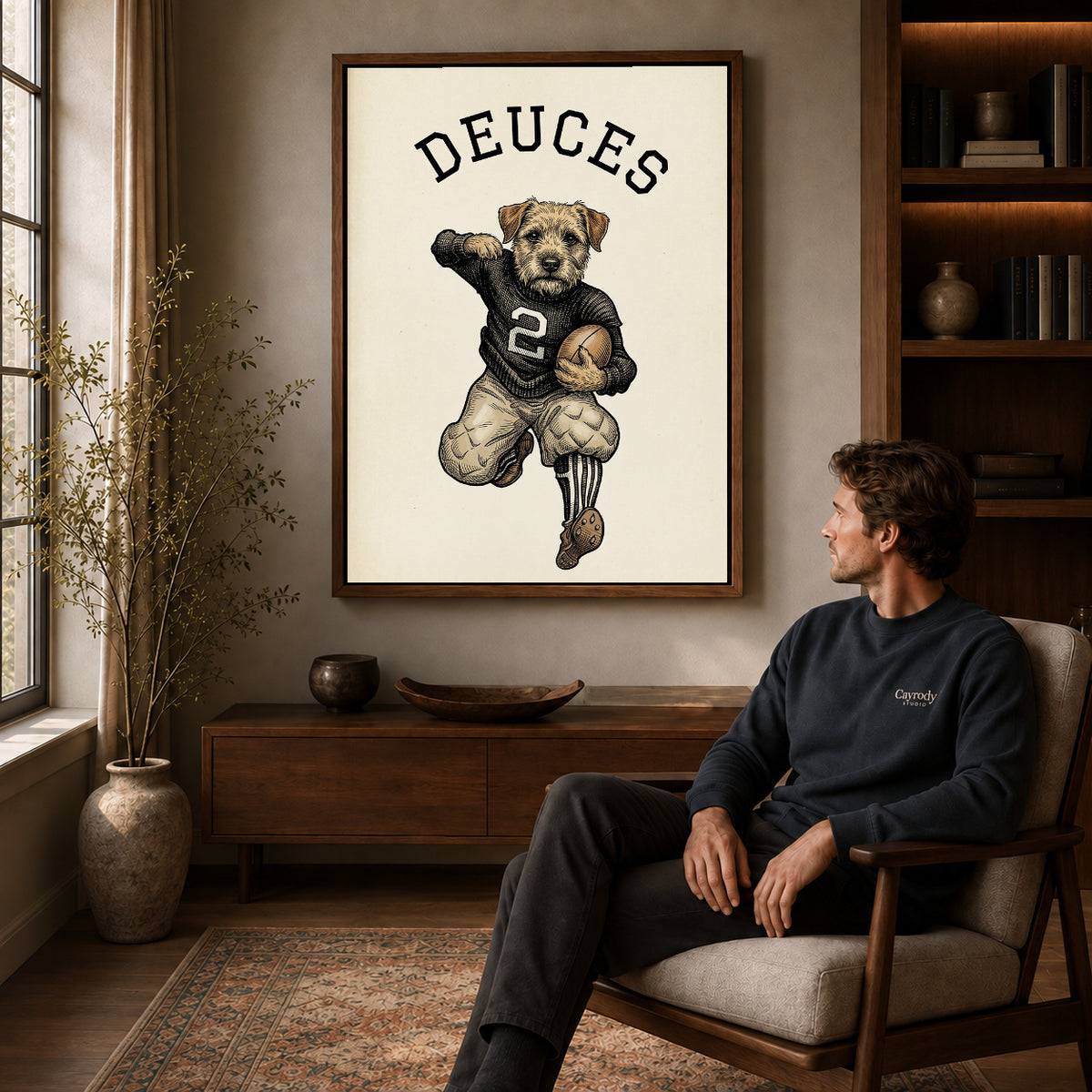 vintage football terrier canvas art in a walnut frame above a console beside a seated man.