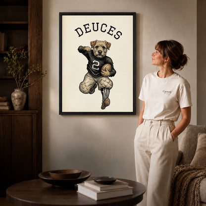 vintage football terrier canvas art in a black frame beside a woman and round wooden table.