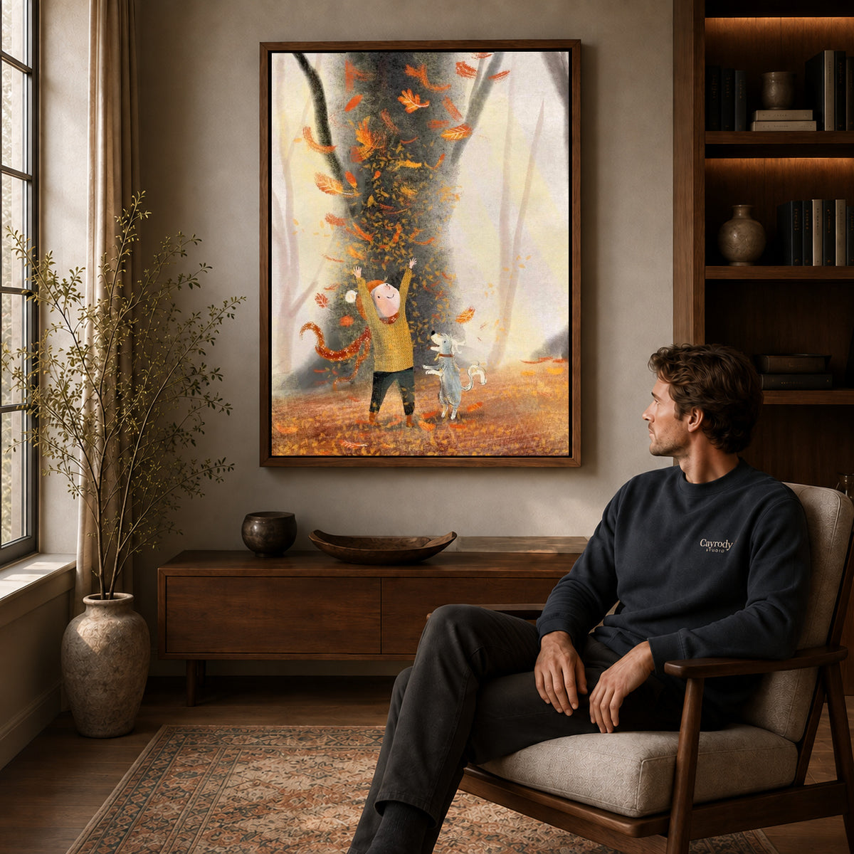 joyful autumn companions canvas art in a walnut frame above a console beside a seated man.