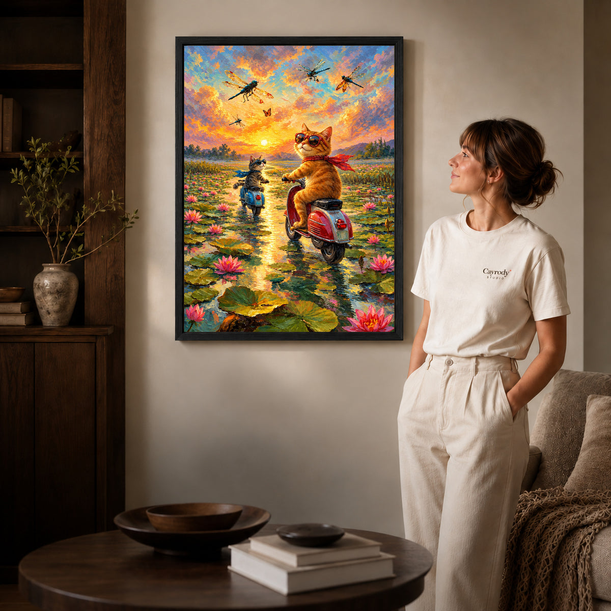 sunset scooter cats canvas art shown in the black frame option against a softly lit wall.