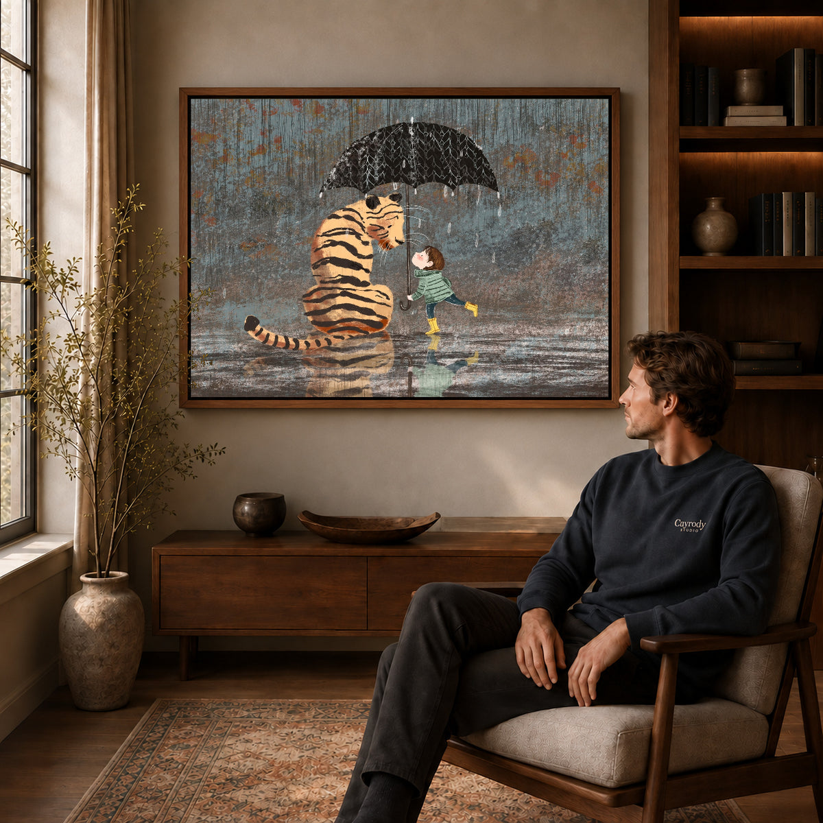 rainy tiger friendship canvas art in a walnut frame above a console beside a seated man.