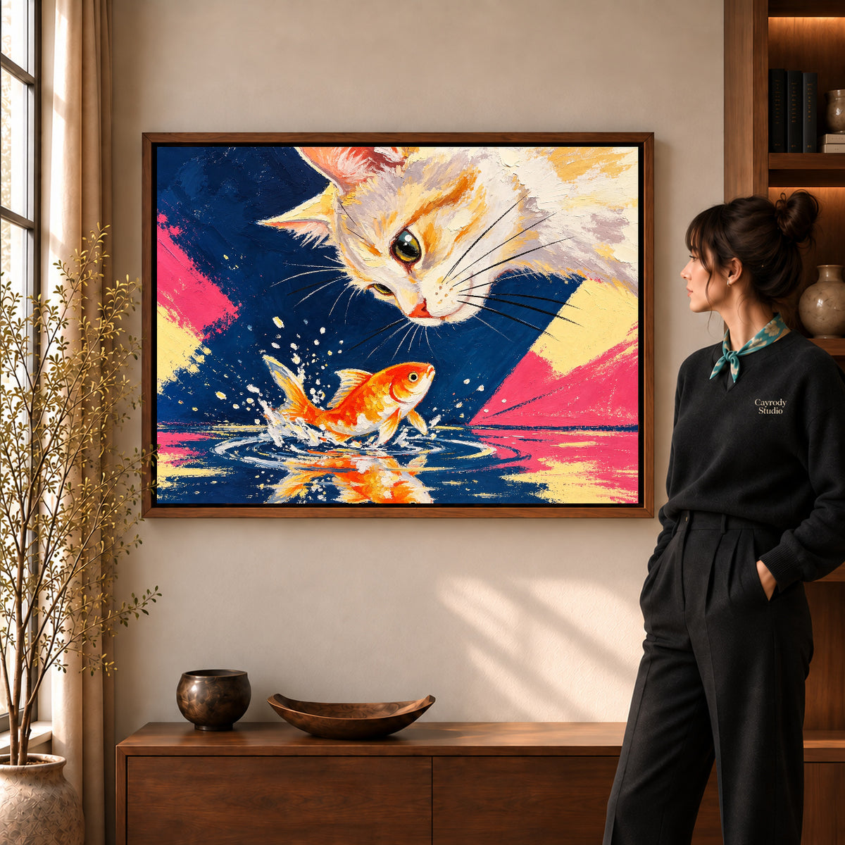 curious cat goldfish canvas art in a walnut frame beside a standing woman and wooden console.