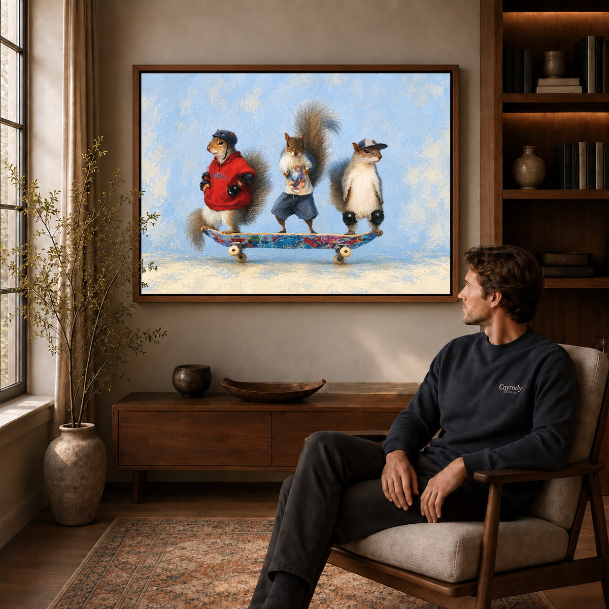 skateboard squirrel trio canvas art in a walnut frame above a console beside a seated man.