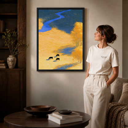 golden meadow cows canvas art shown in the black frame option against a softly lit wall.