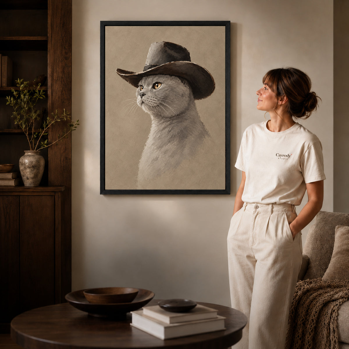quiet cowboy cat canvas art shown in the black frame option against a softly lit wall.