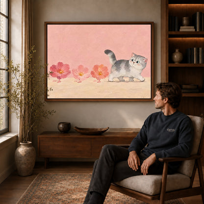 sweet blossom kitten canvas art in a walnut frame above a console beside a seated man.