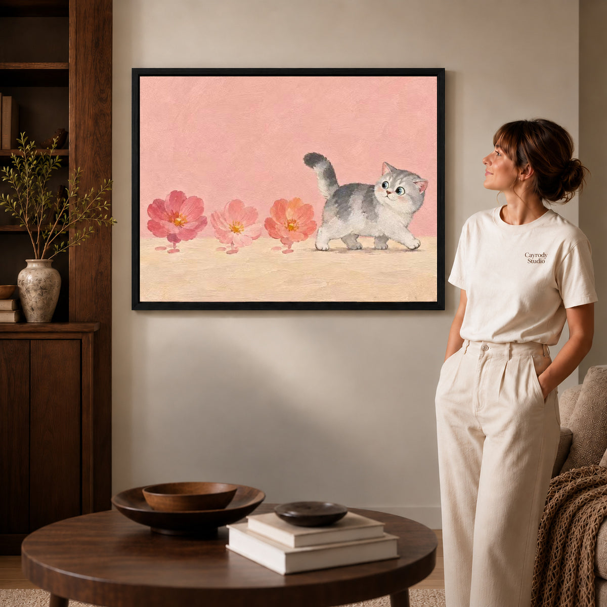sweet blossom kitten canvas art shown in the black frame option against a softly lit wall.