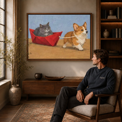 corgi cat boat adventure canvas art in a walnut frame above a console beside a seated man.