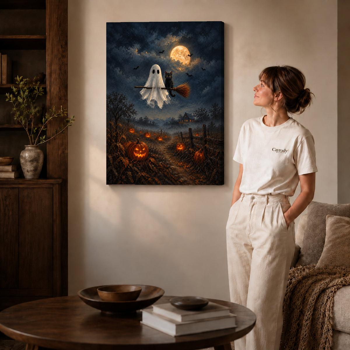 moonlit ghost cat ride canvas art on gallery-wrapped canvas with natural edge shading beside a standing woman.