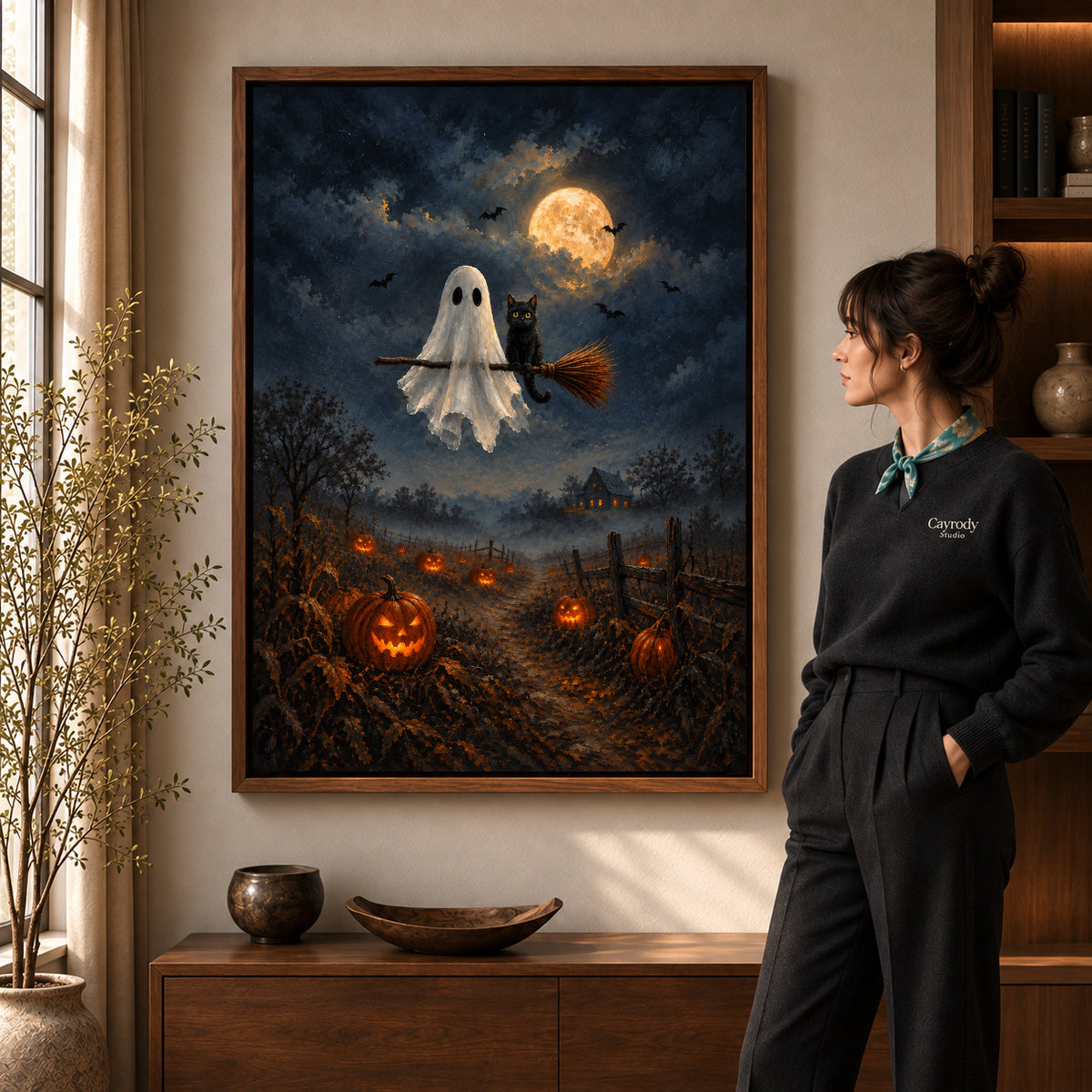 moonlit ghost cat ride canvas art shown in the walnut frame option within a warm living room.