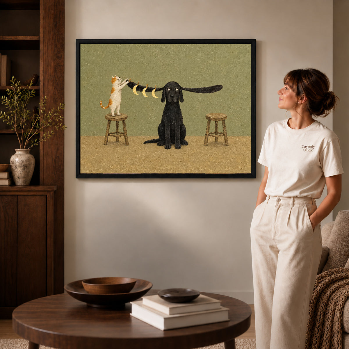 moon hanging pet friends canvas art shown in the black frame option against a softly lit wall.