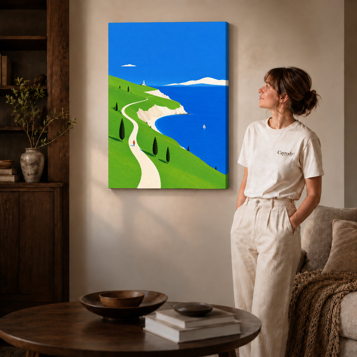 bright coastal path canvas art on gallery-wrapped canvas with natural edge shading beside a standing woman.