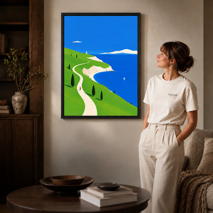 bright coastal path canvas art shown in the black frame option against a softly lit wall.