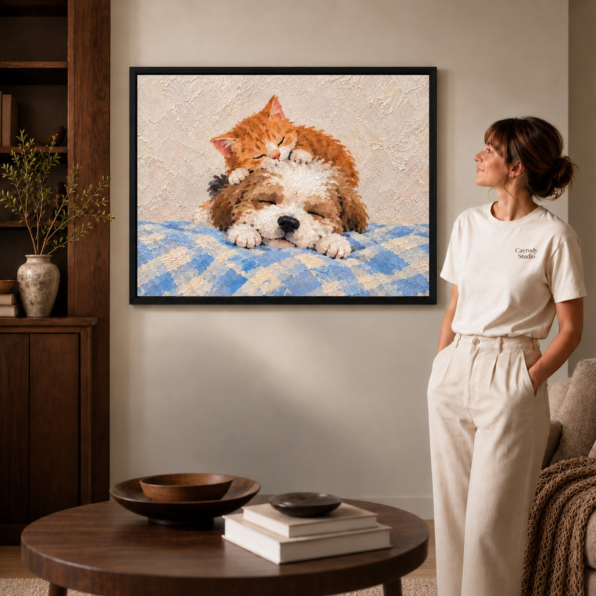sleepy kitten puppy canvas art shown in the black frame option against a softly lit wall.