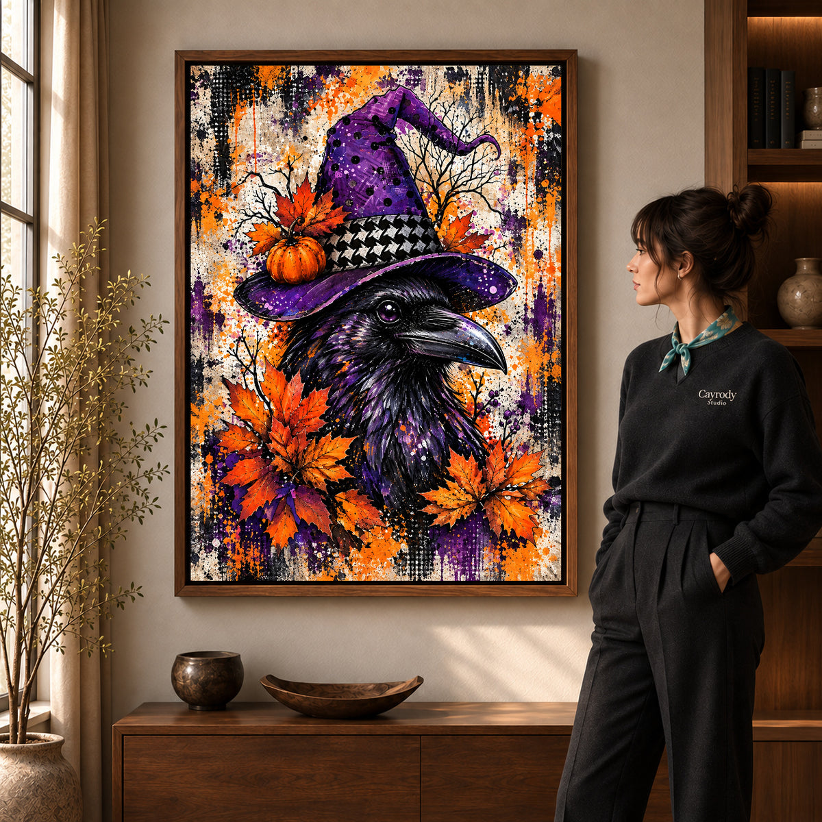 purple hat raven canvas art in a walnut frame beside a standing woman and wooden console.