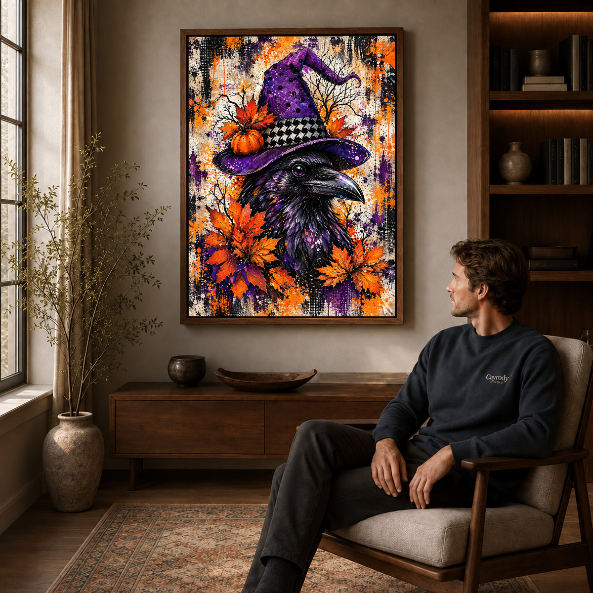 purple hat raven canvas art in a walnut frame above a console beside a seated man.