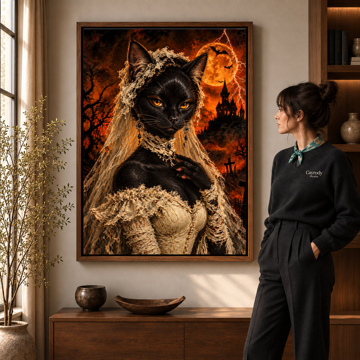 gothic lace cat canvas art in a walnut frame beside a standing woman and wooden console.