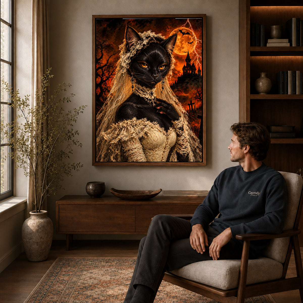 gothic lace cat canvas art in a walnut frame above a console beside a seated man.