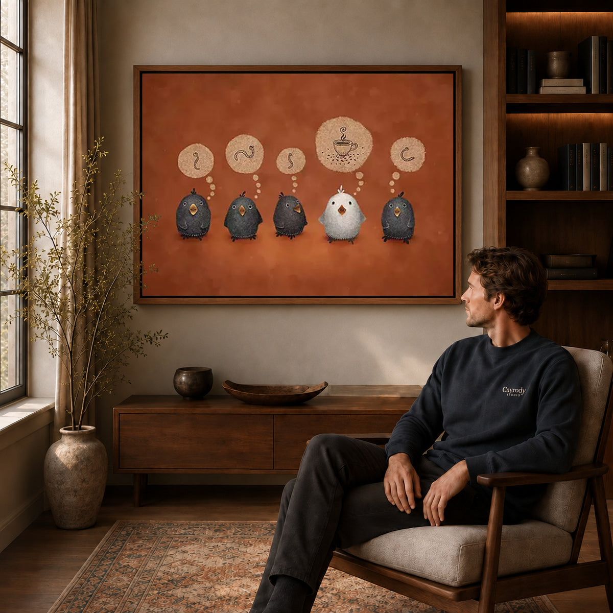 coffee dreaming birds canvas art in a walnut frame above a console beside a seated man.