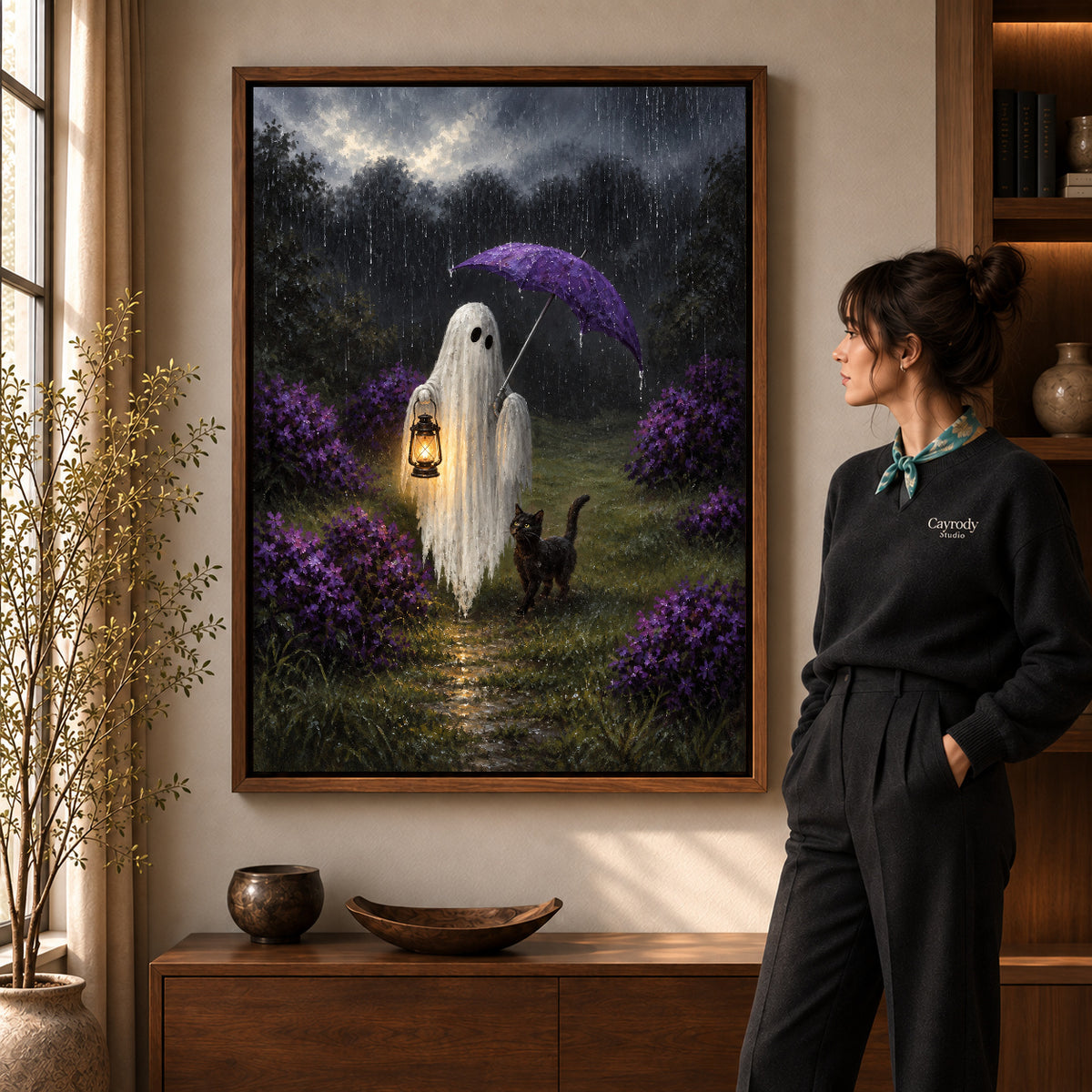 rainy ghost cat companions canvas art in a walnut frame beside a standing woman and wooden console.