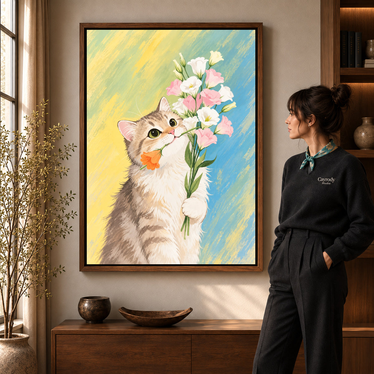 sweet kitten bouquet canvas art in a walnut frame beside a standing woman and wooden console.
