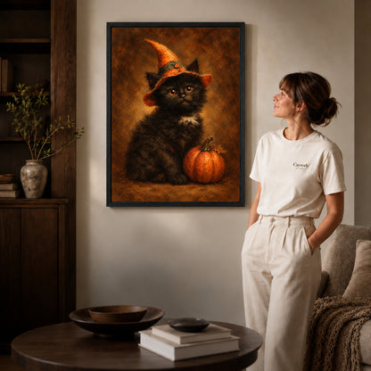 autumn witch kitten canvas art shown in the black frame option against a softly lit wall.