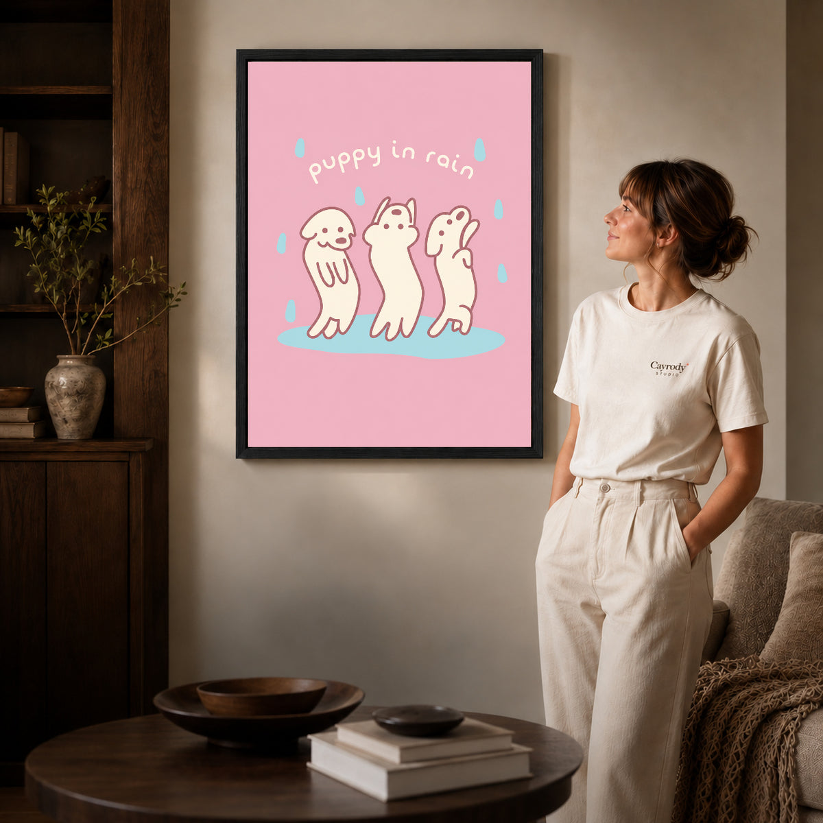 rain dancing puppies canvas art shown in the black frame option against a softly lit wall.