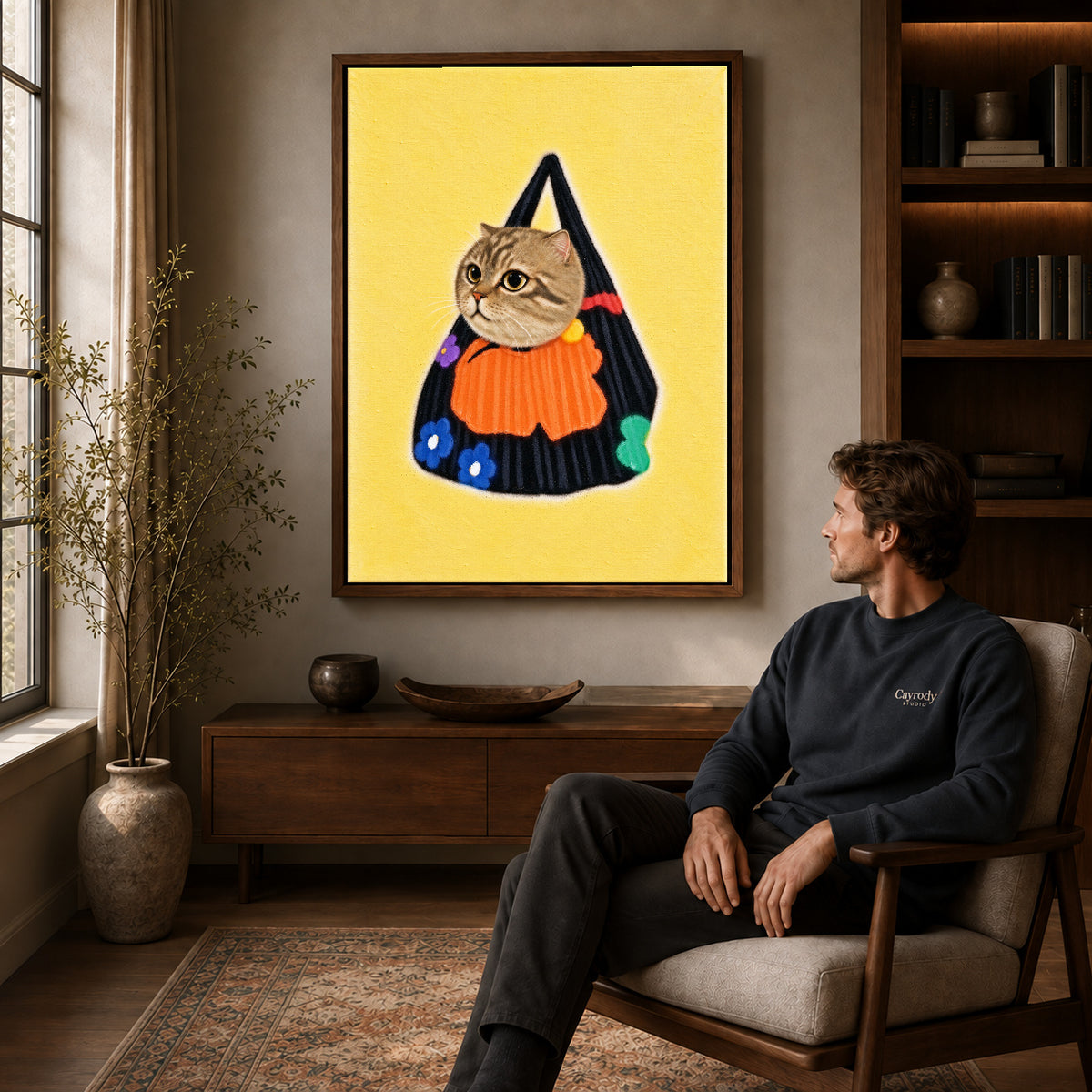 tabby tote companion canvas art in a walnut frame above a console beside a seated man.