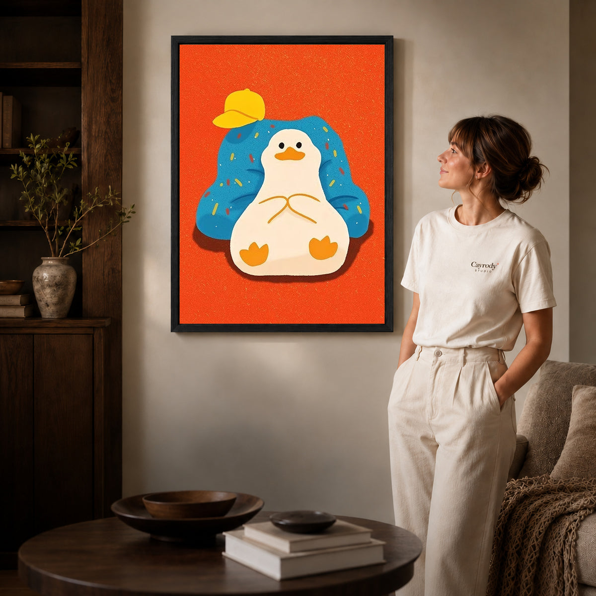 relaxed armchair duck canvas art shown in the black frame option against a softly lit wall.